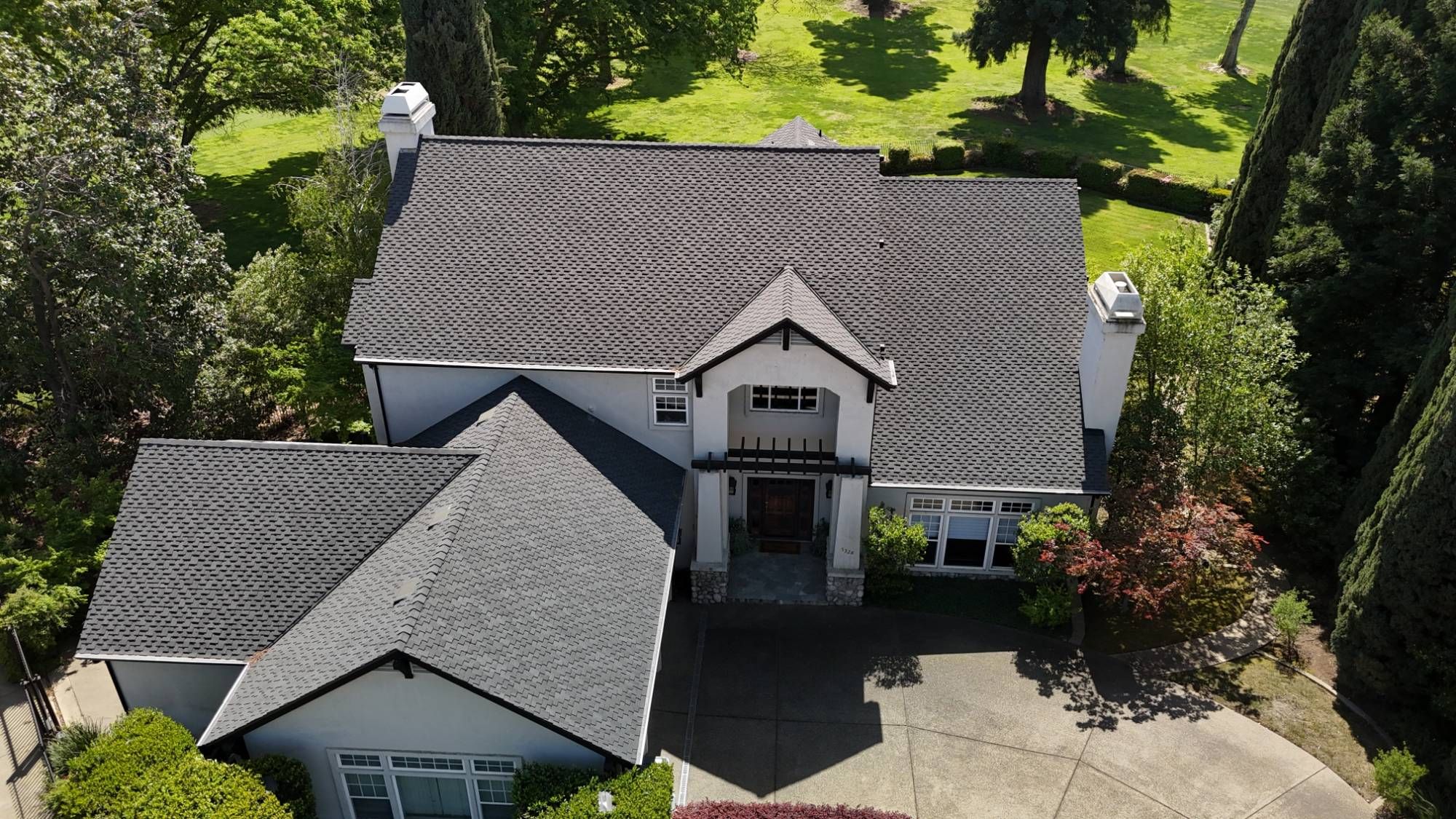 Aerial view of a Fair Oaks home with a new CertainTeed Presidential Shake TL roof in Charcoal Black
