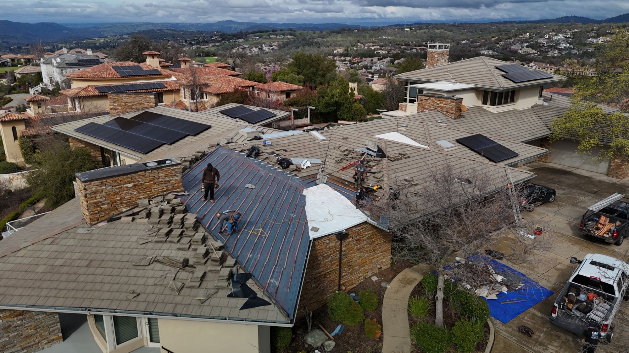 GM Roofing crew installing new underlayment and battens before resetting the concrete tile on a Sacramento home